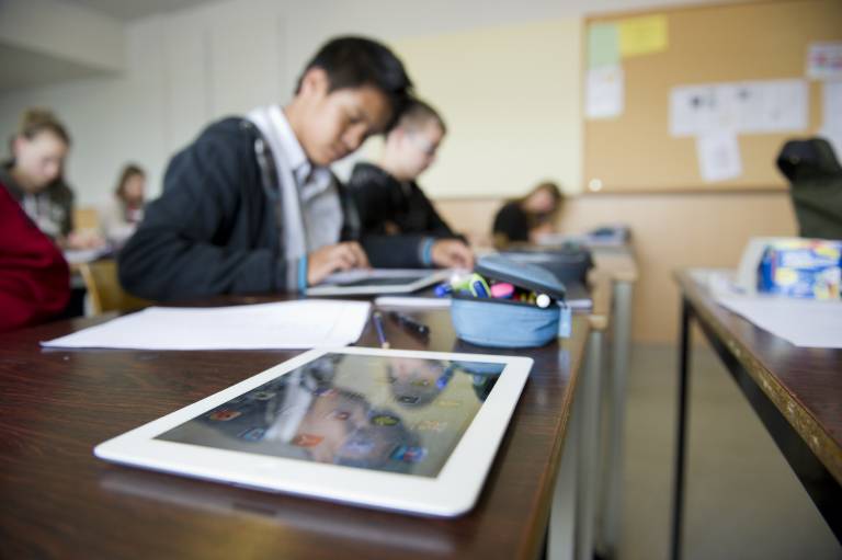 Unterricht in einer Schulklasse. Die Kinder arbeiten mit mobilen Endgeräten 