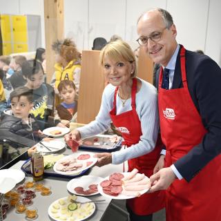 Uschi Glas und Staatssekretär Dr. Urban Mauer bieten Schülerinnen und Schülern der Essener Bischof-von-Ketteler-Schule im Rahmen der "brotZeit" ein Frühstück an.